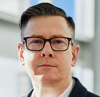 Alexander Hughes, PDG d'une entreprise de crypto-trading, portrait.